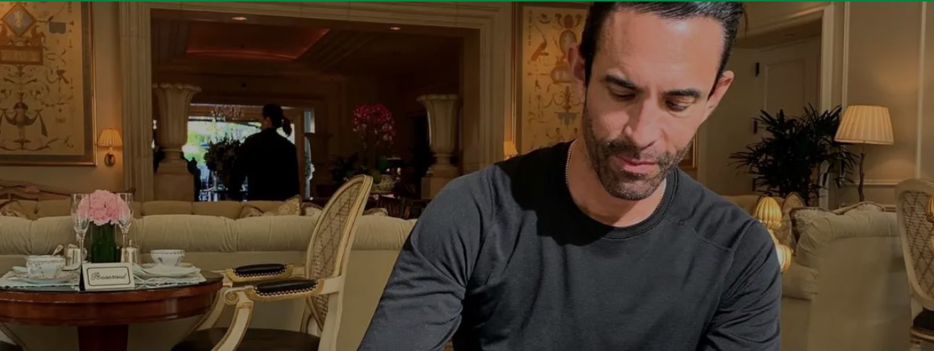 Jorge Cruise seated in a hotel lounge with a cup of coffee, from the 24Life feature on his morning routine