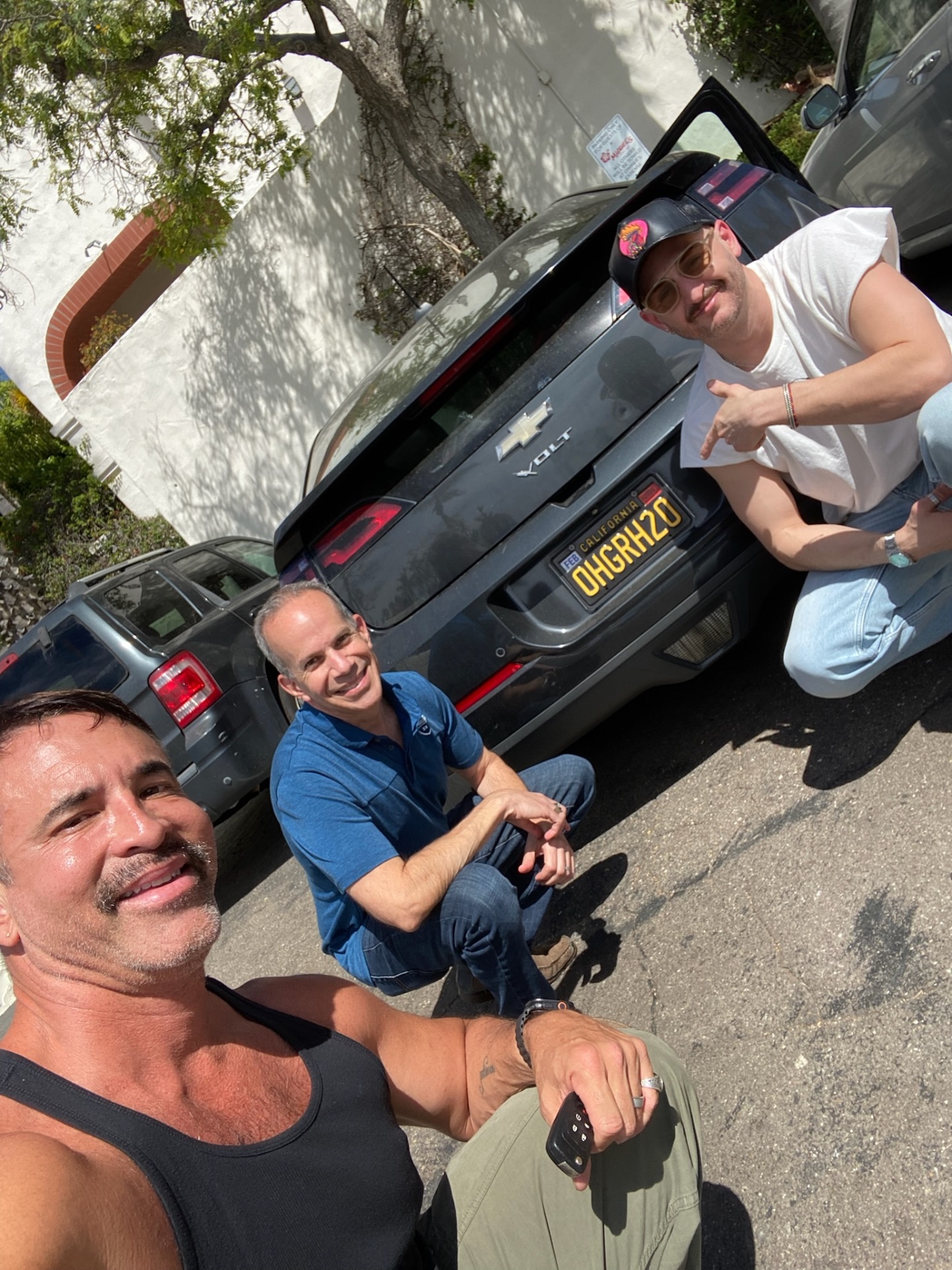 Jorge with Sigma Chi brothers Rich and Stephan behind Dad's 2015 Chevy Volt